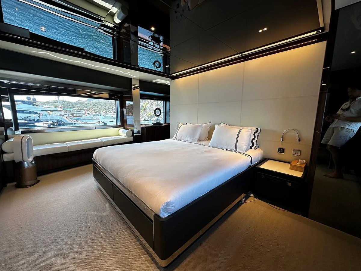The master stateroom features a luxurious bed with ample natural light and elegant decor. aboard 4SEAS Yacht for Sale