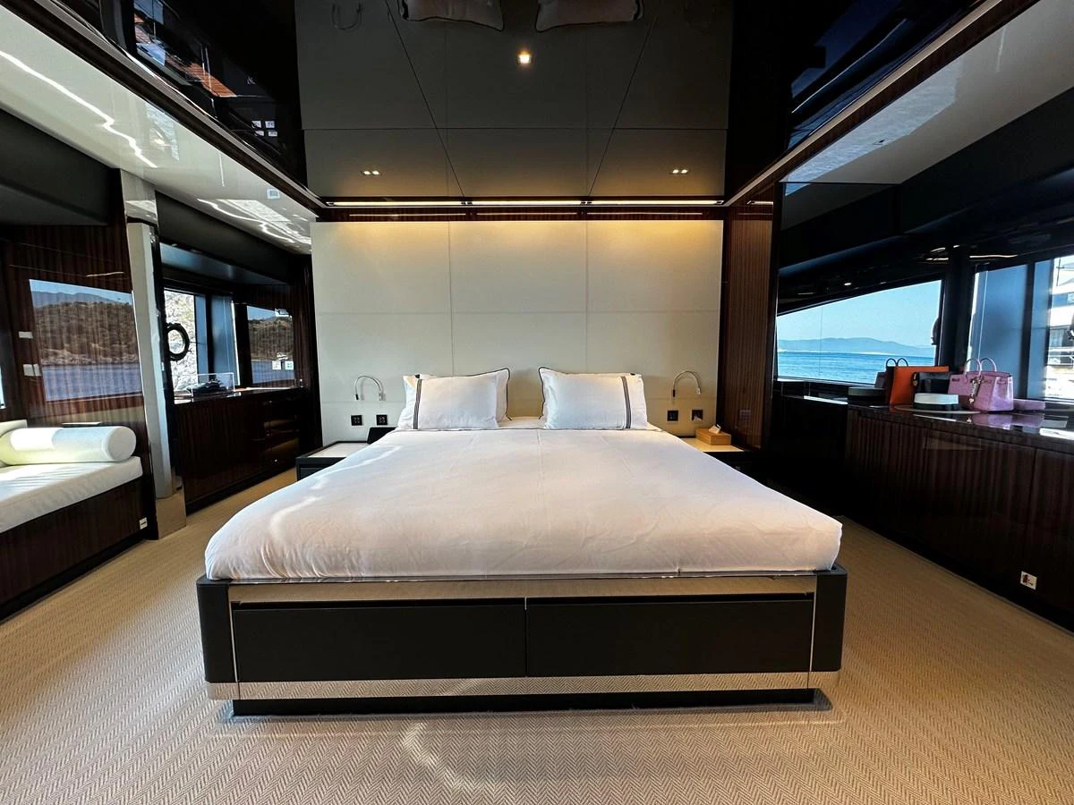 The master stateroom features a luxurious bed with ample natural light from large windows. aboard 4SEAS Yacht for Sale