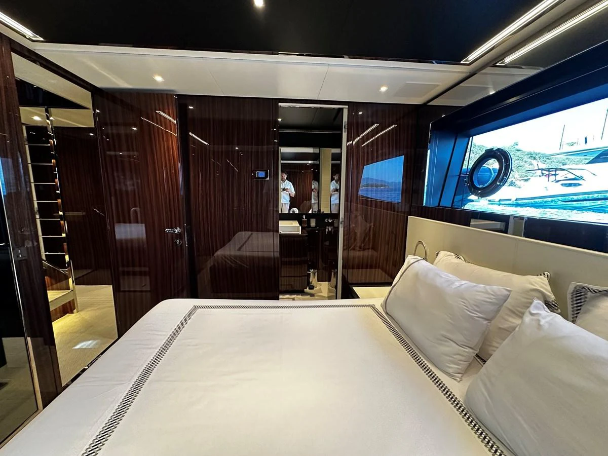 The master stateroom features luxurious bedding and elegant wood paneling, offering a serene retreat. aboard 4SEAS Yacht for Sale