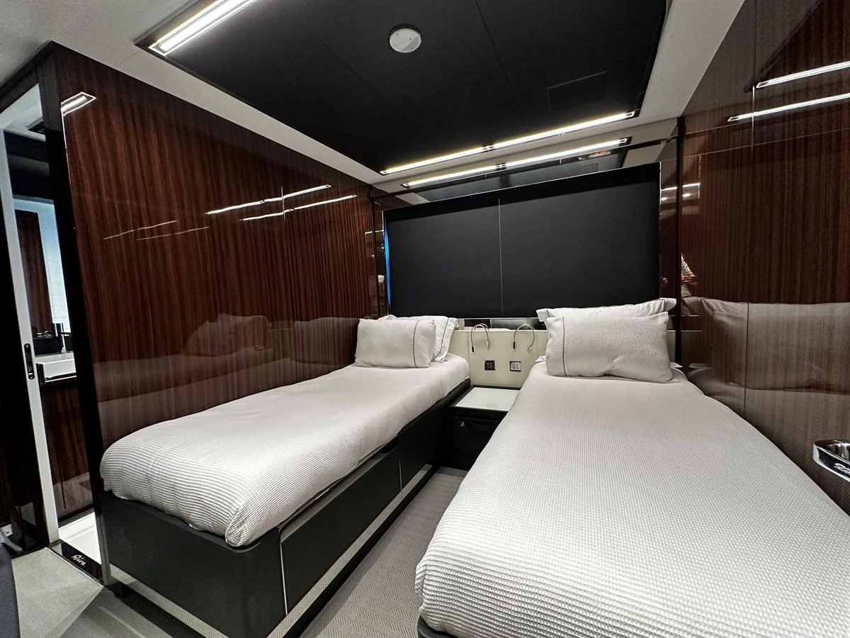 The twin stateroom features sleek, modern design with two comfortable beds and luxurious finishes. aboard 4SEAS Yacht for Sale