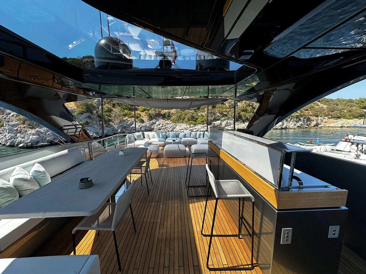 The aft deck features a spacious seating area with modern furnishings and a sleek design. aboard 4SEAS Yacht for Sale
