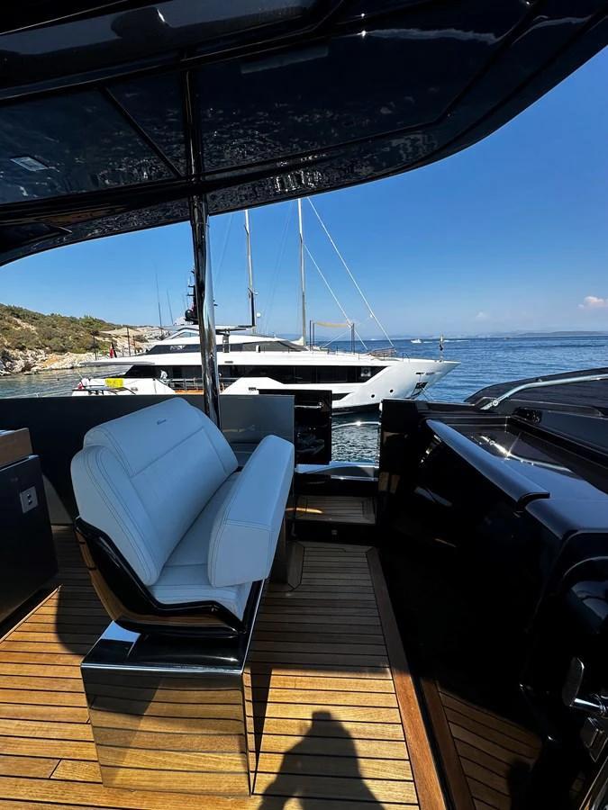 The aft deck offers a comfortable seating area with a view of the surrounding waters and nearby yachts. aboard 4SEAS Yacht for Sale