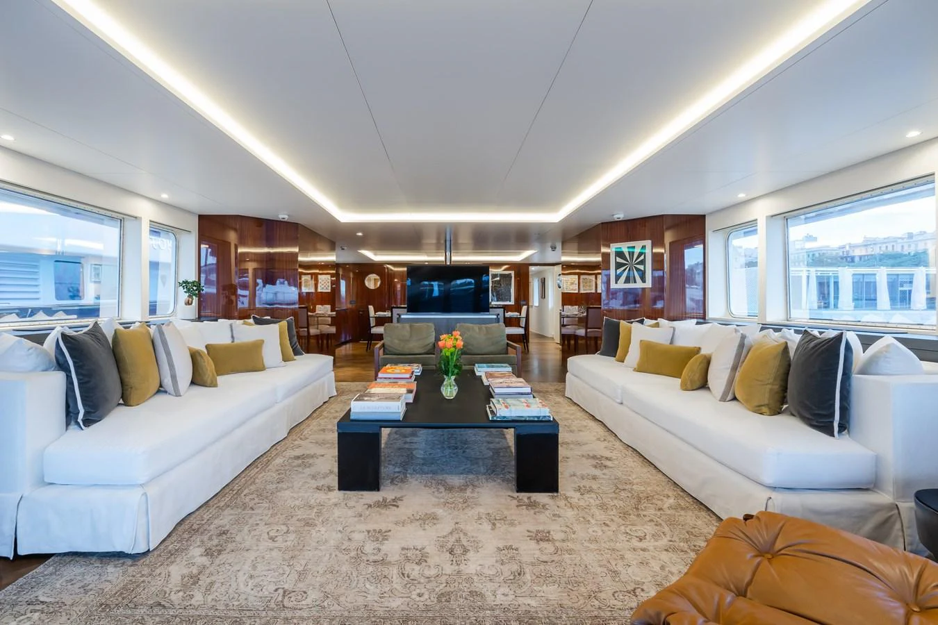 The spacious salon features elegant seating and a sophisticated ambiance. aboard MP5 Yacht for Sale