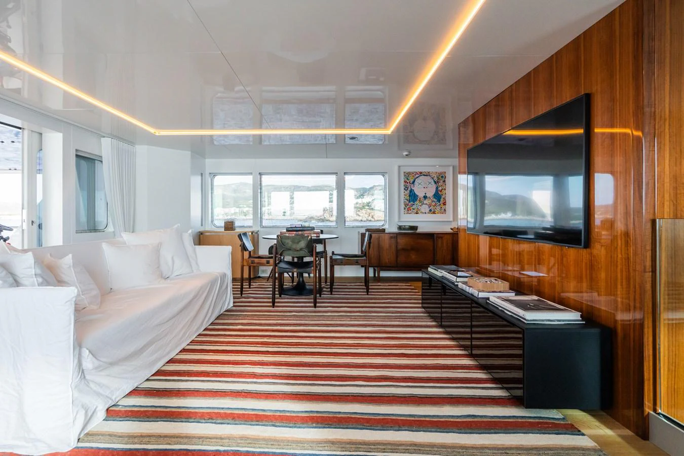 The salon features a comfortable seating area with a large TV and stylish decor. aboard MP5 Yacht for Sale