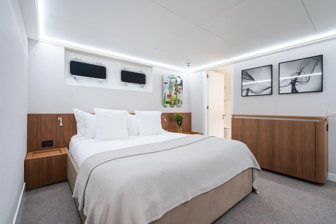 A serene stateroom featuring a large bed, modern decor, and ample natural light. aboard MP5 Yacht for Sale