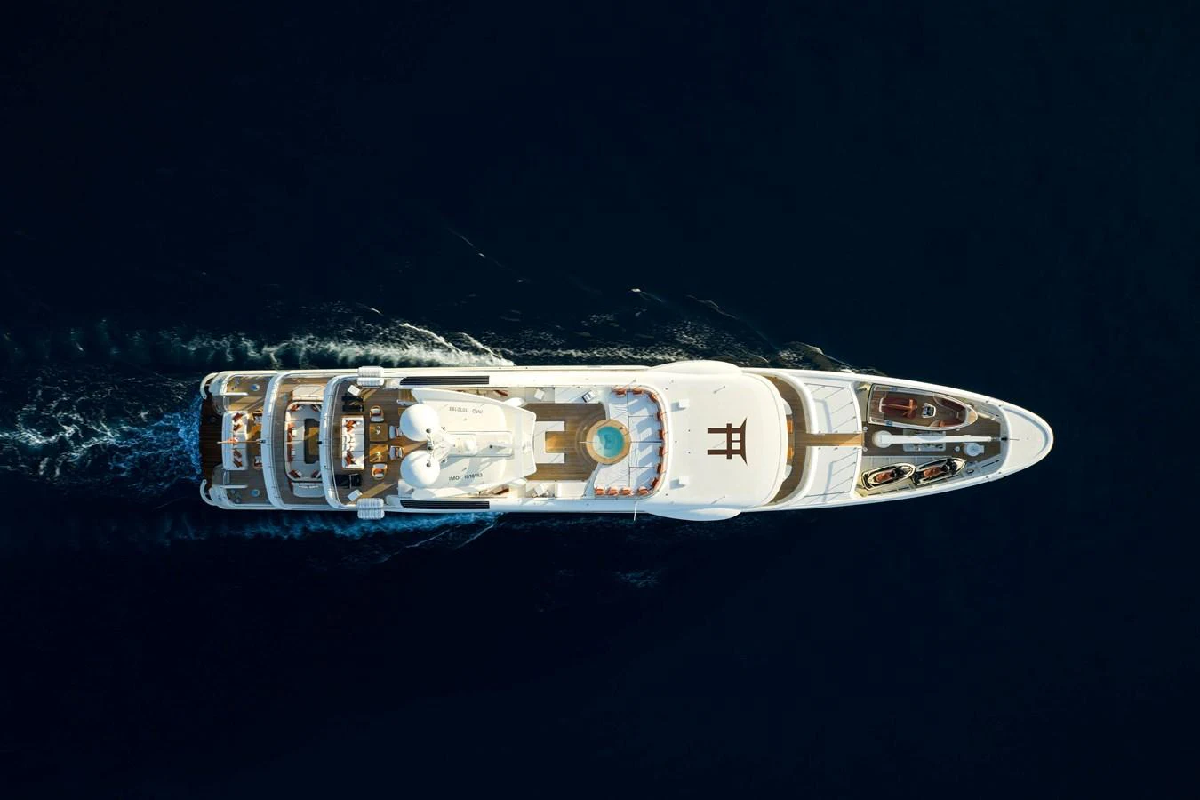 An aerial view of a luxurious yacht cruising through deep blue waters. aboard GRACE Yacht for Sale