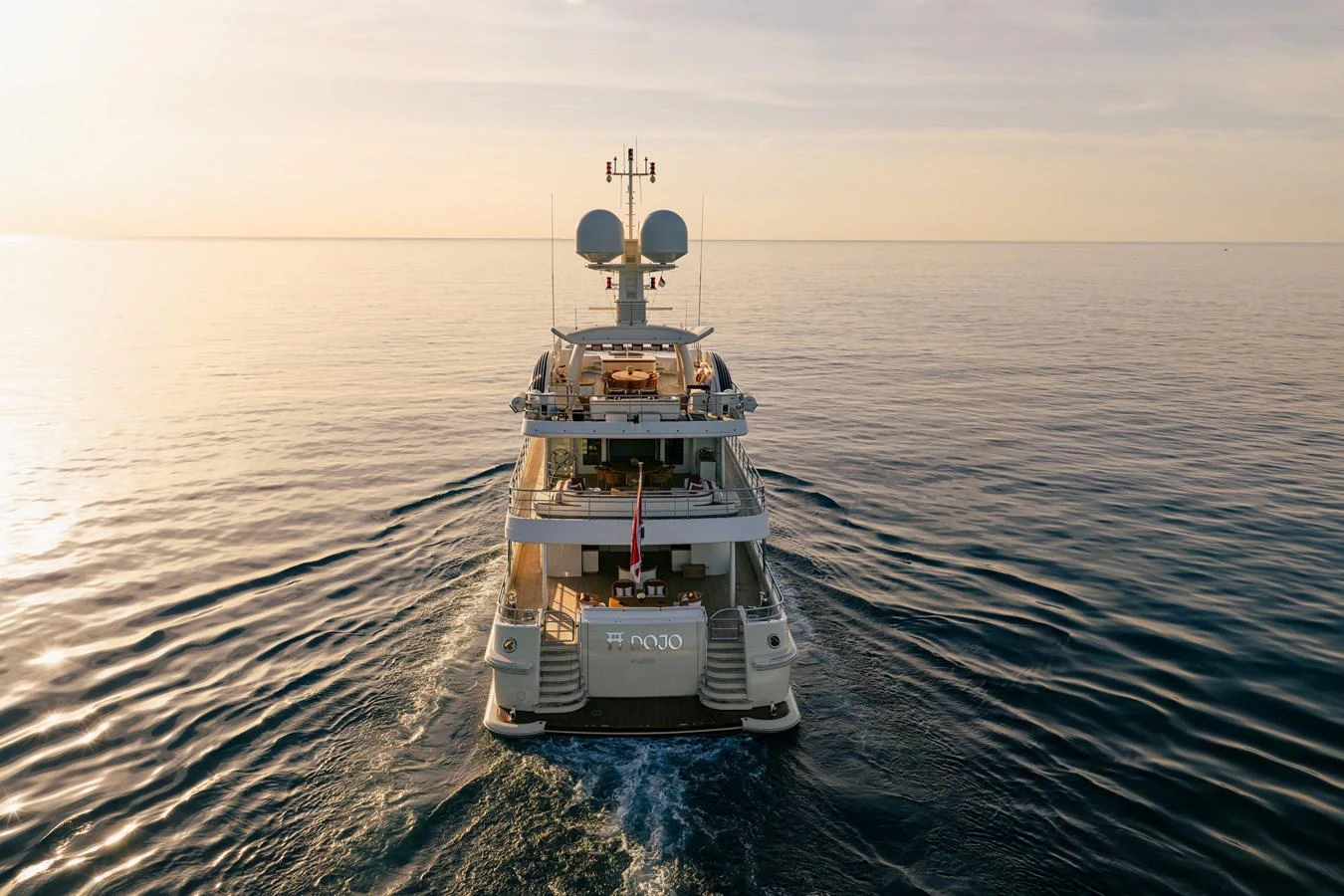 A luxurious yacht cruises through calm waters at sunset, showcasing its elegant design and advanced technology. aboard GRACE Yacht for Sale