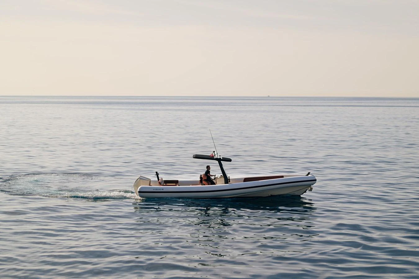 A sleek tender glides smoothly across calm waters, showcasing its elegant design. aboard GRACE Yacht for Sale