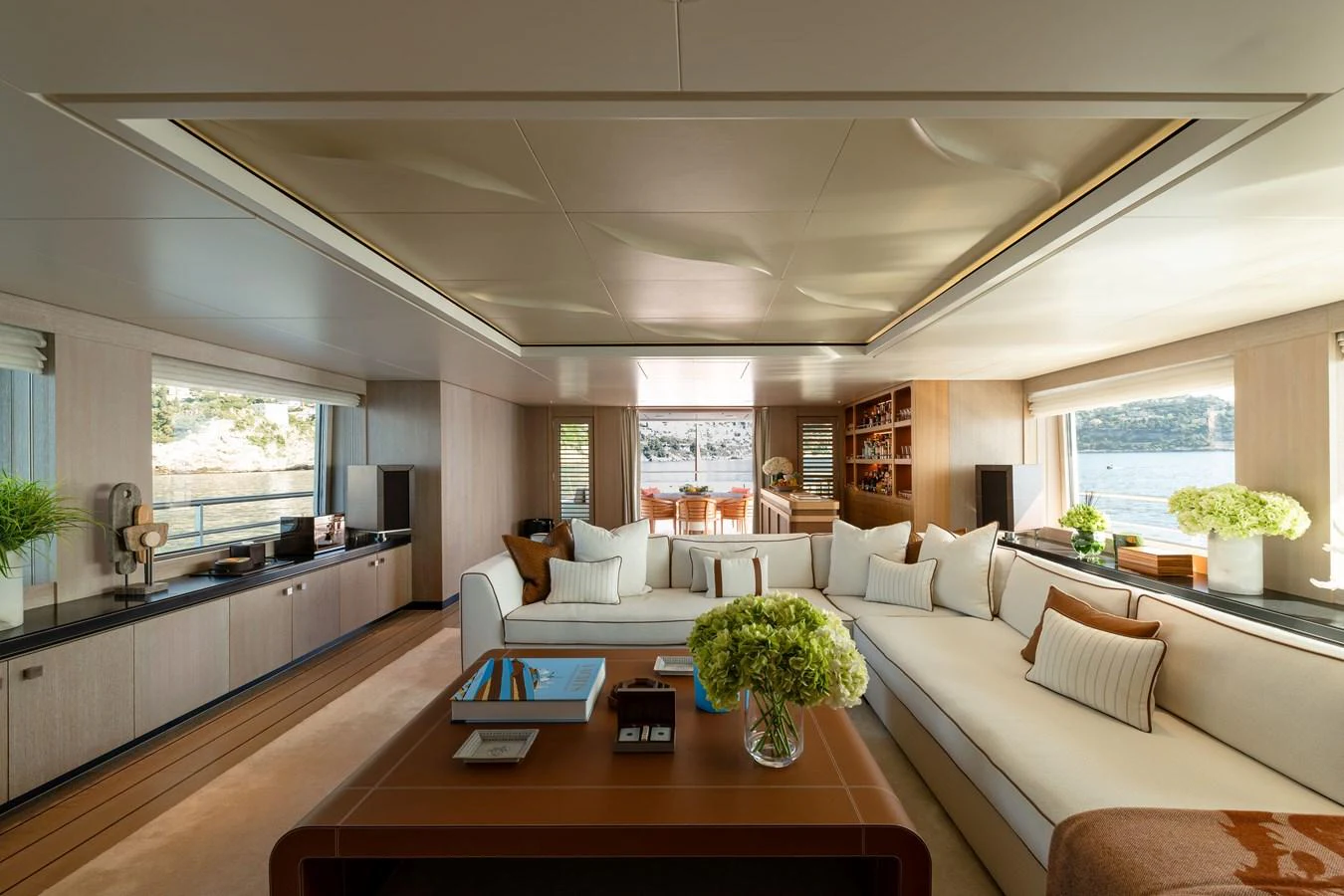 The yacht's salon offers a spacious and luxurious seating area with large windows providing stunning views. aboard GRACE Yacht for Sale