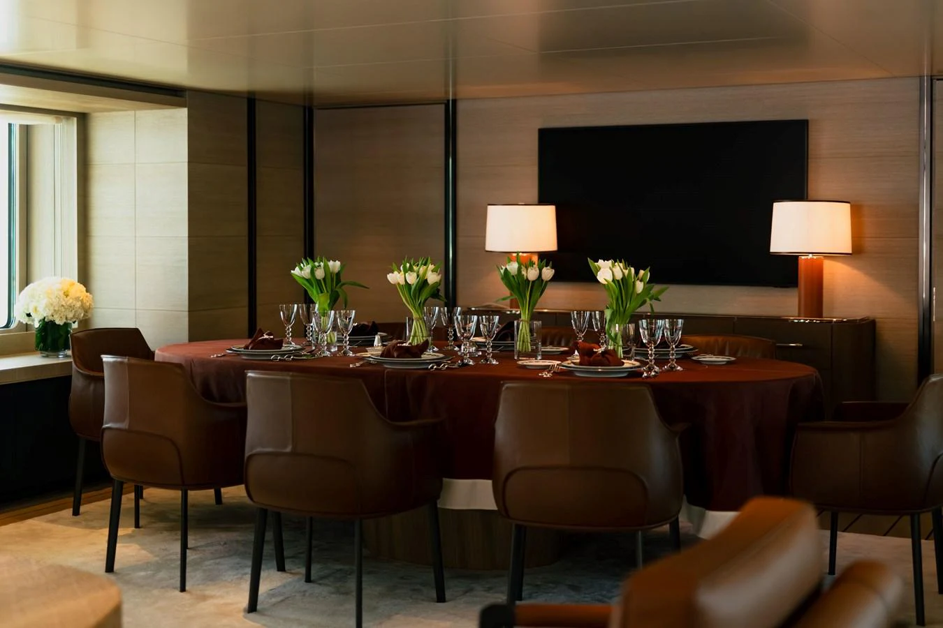 The yacht's dining area features a sophisticated table setting with elegant decor and comfortable seating. aboard GRACE Yacht for Sale