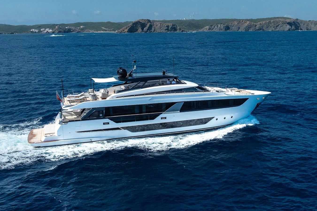 A sleek and modern yacht cruises through the open sea, showcasing its elegant design and spacious deck areas. aboard FREYA Yacht for Sale