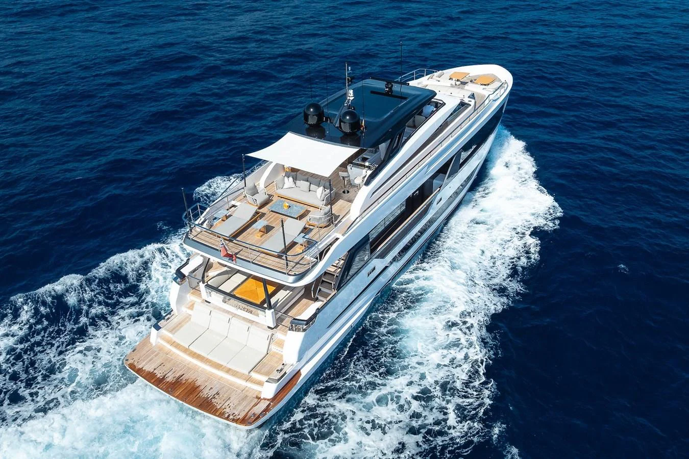 A luxurious yacht cruises through the open sea, showcasing its sleek design and spacious decks. aboard FREYA Yacht for Sale