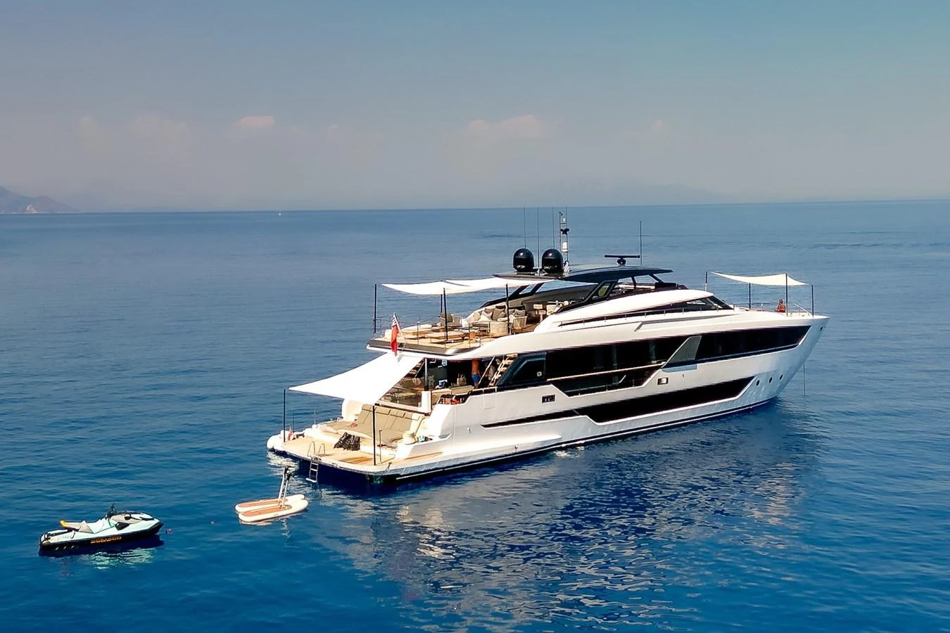 A sleek and modern yacht glides gracefully on calm blue waters, showcasing its luxurious design and spacious decks. aboard FREYA Yacht for Sale