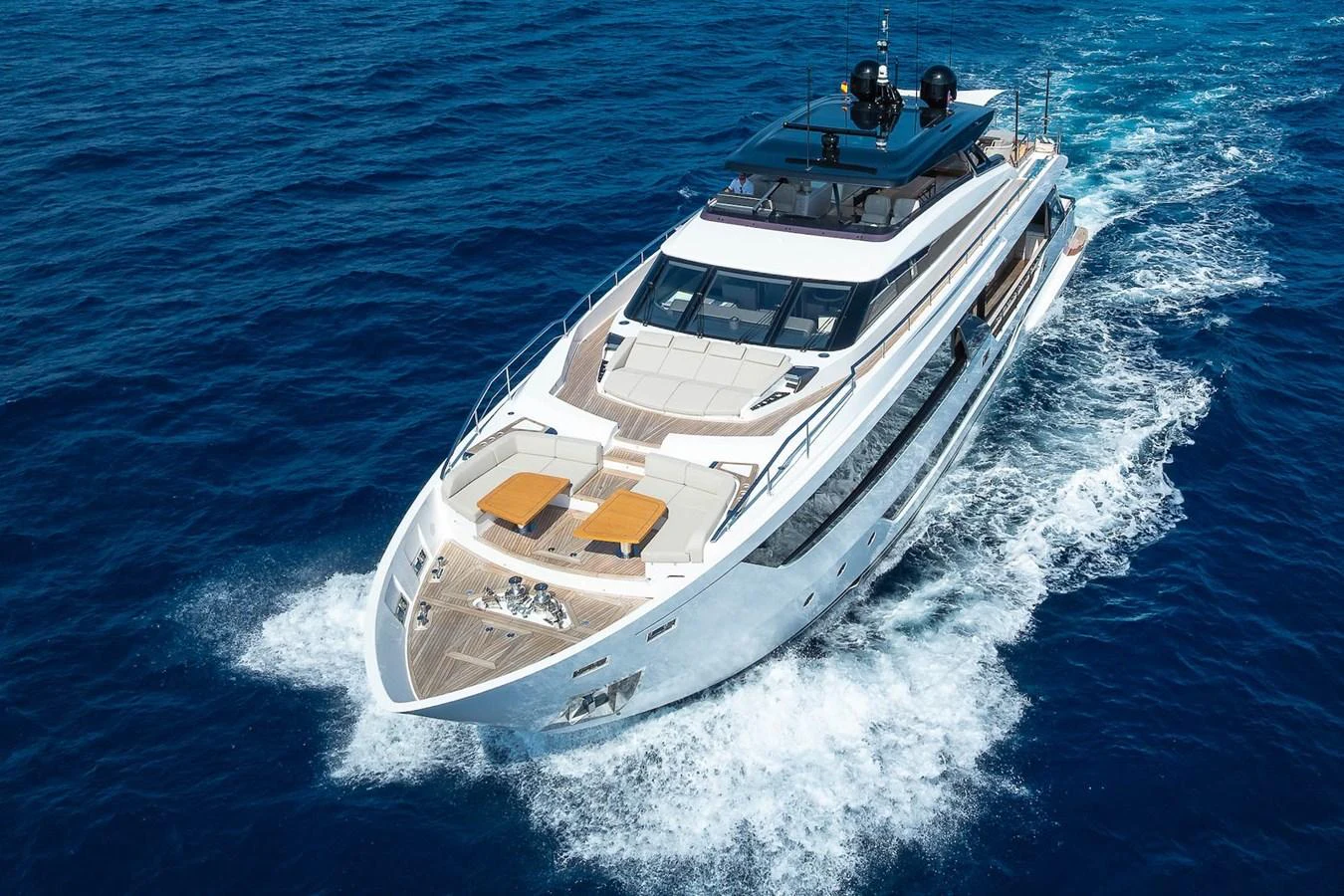 A sleek and modern yacht cruises through the deep blue sea, showcasing its luxurious design and spacious deck. aboard FREYA Yacht for Sale