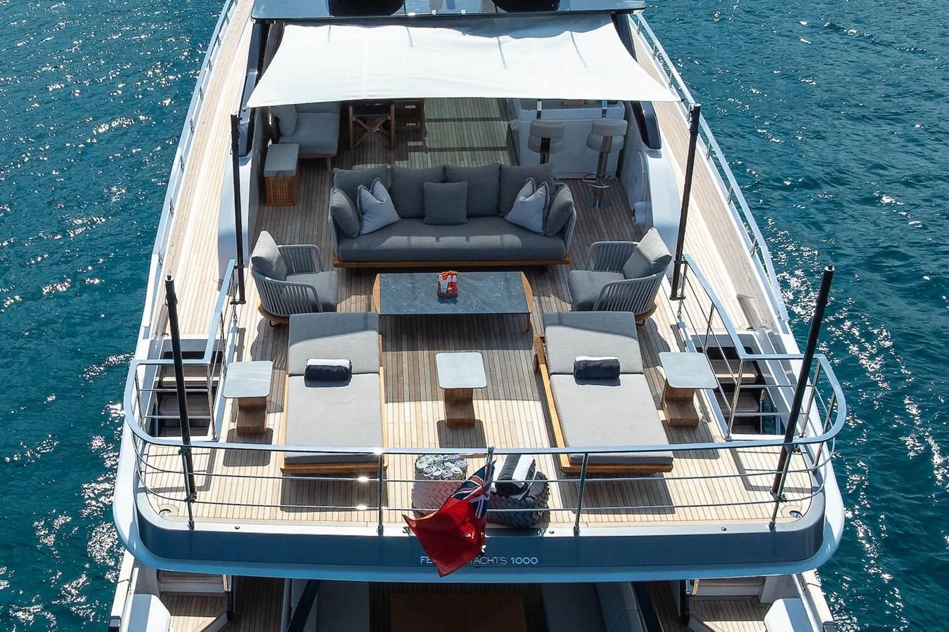 The aft deck offers a spacious and inviting area for relaxation and socializing, complete with comfortable seating and a shaded canopy. aboard FREYA Yacht for Sale