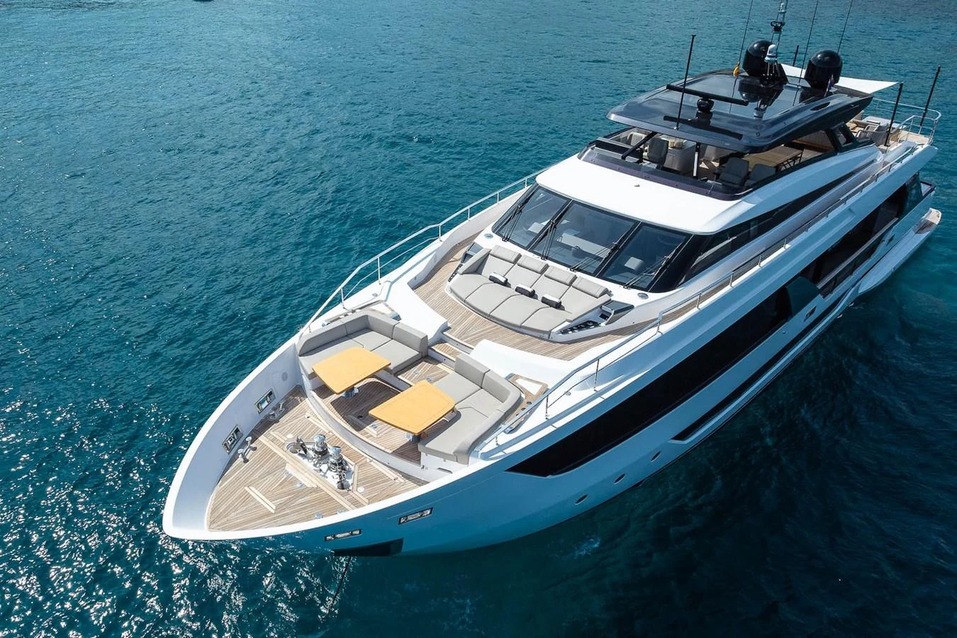 A sleek and modern yacht cruising on clear blue waters, showcasing its luxurious deck and spacious layout. aboard FREYA Yacht for Sale