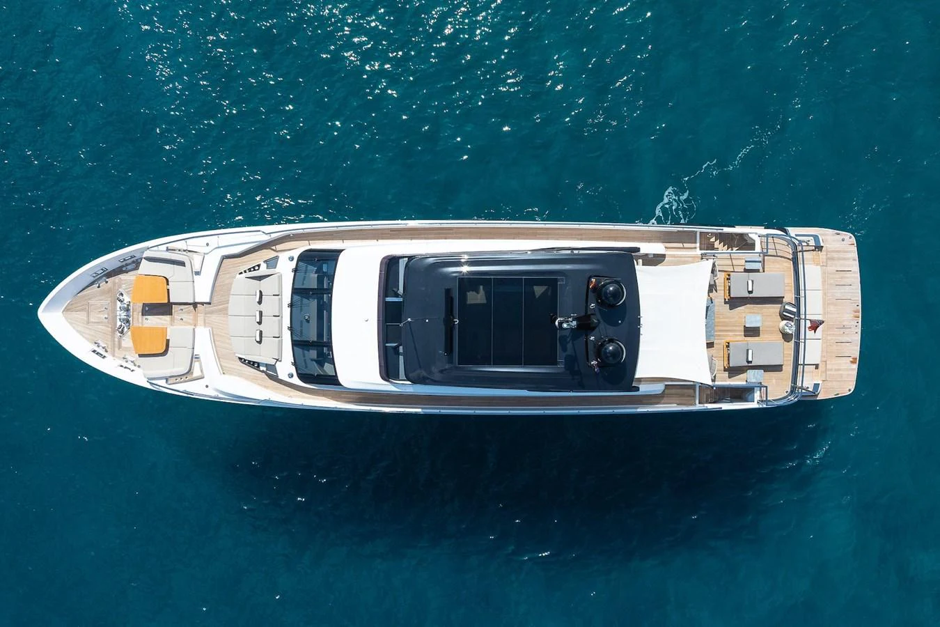 Aerial view of a sleek yacht showcasing its expansive deck and luxurious amenities. aboard FREYA Yacht for Sale