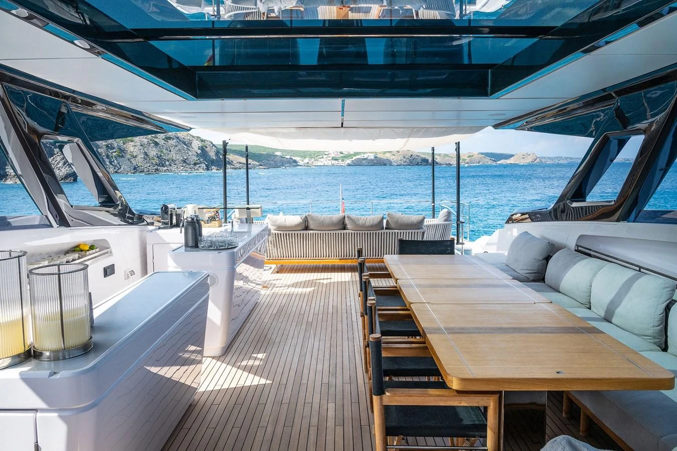 The aft deck features a spacious dining area with a stunning view of the sea. aboard FREYA Yacht for Sale