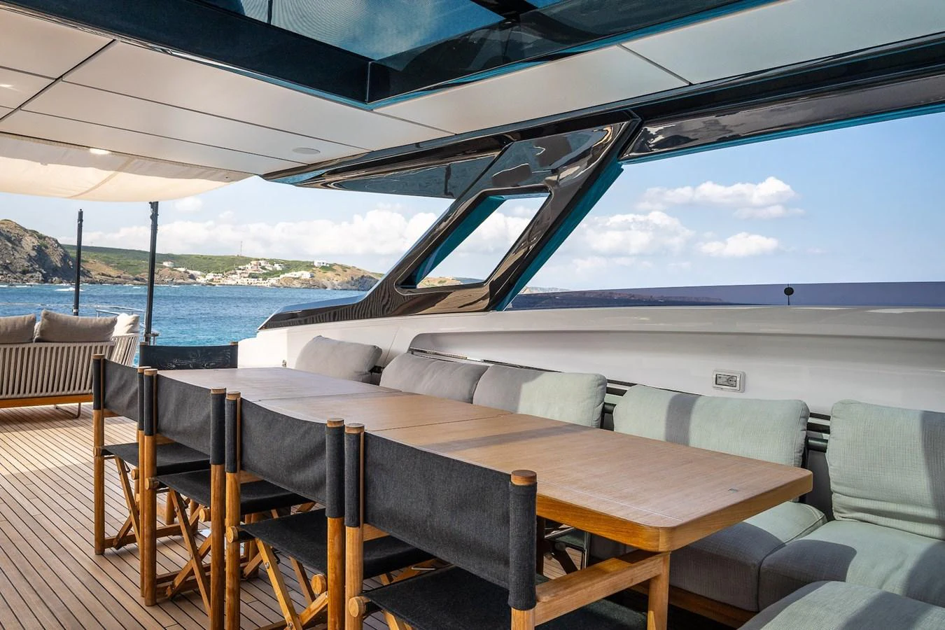 The aft deck features a spacious dining area with a stunning ocean view. aboard FREYA Yacht for Sale