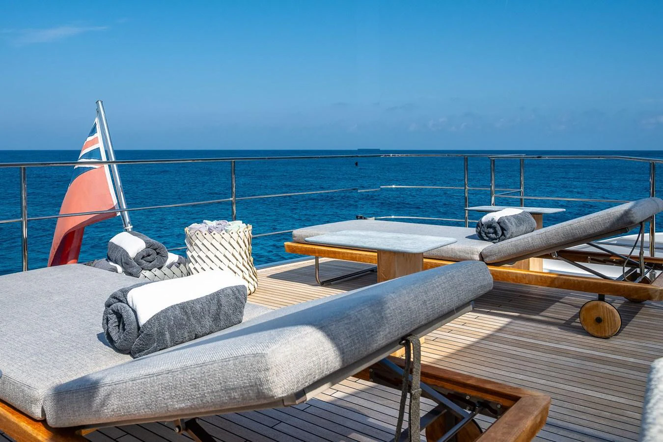 The sundeck offers a serene space with plush sun loungers and a stunning ocean view. aboard FREYA Yacht for Sale