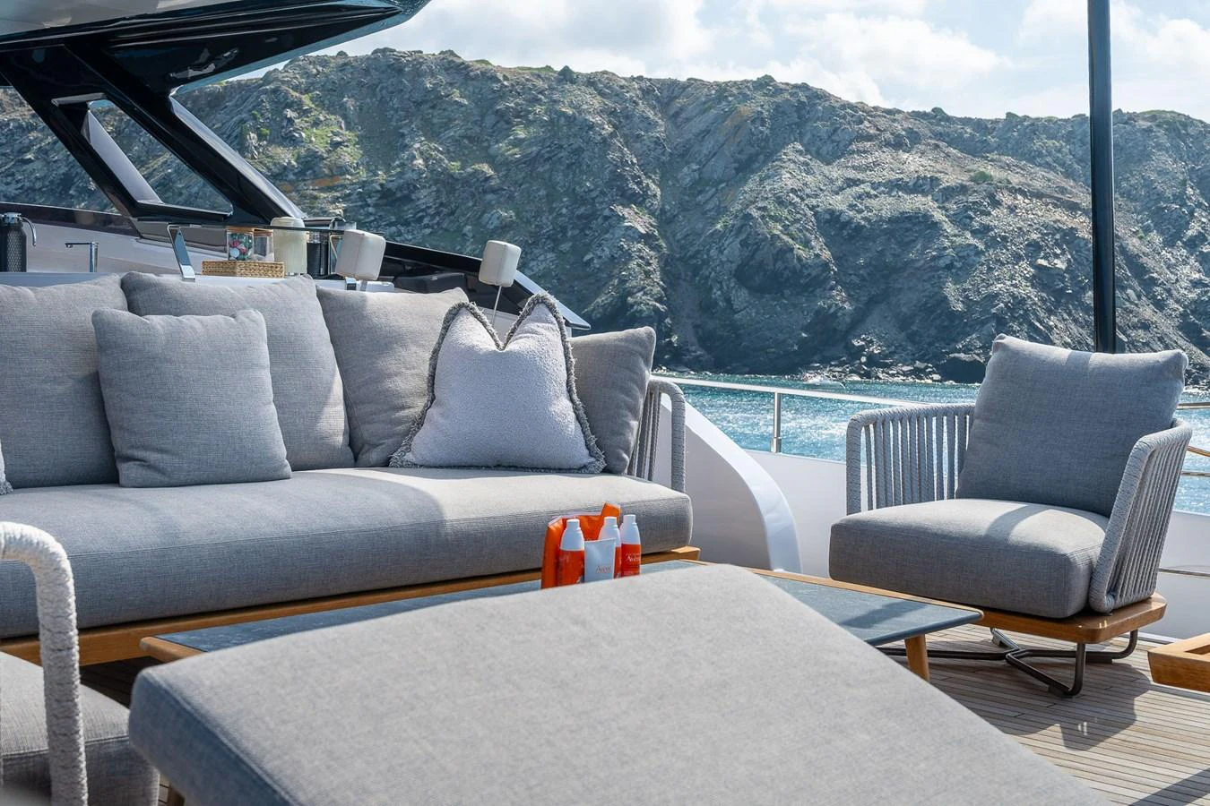 The aft deck features plush seating with a stunning view of the rocky coastline. aboard FREYA Yacht for Sale