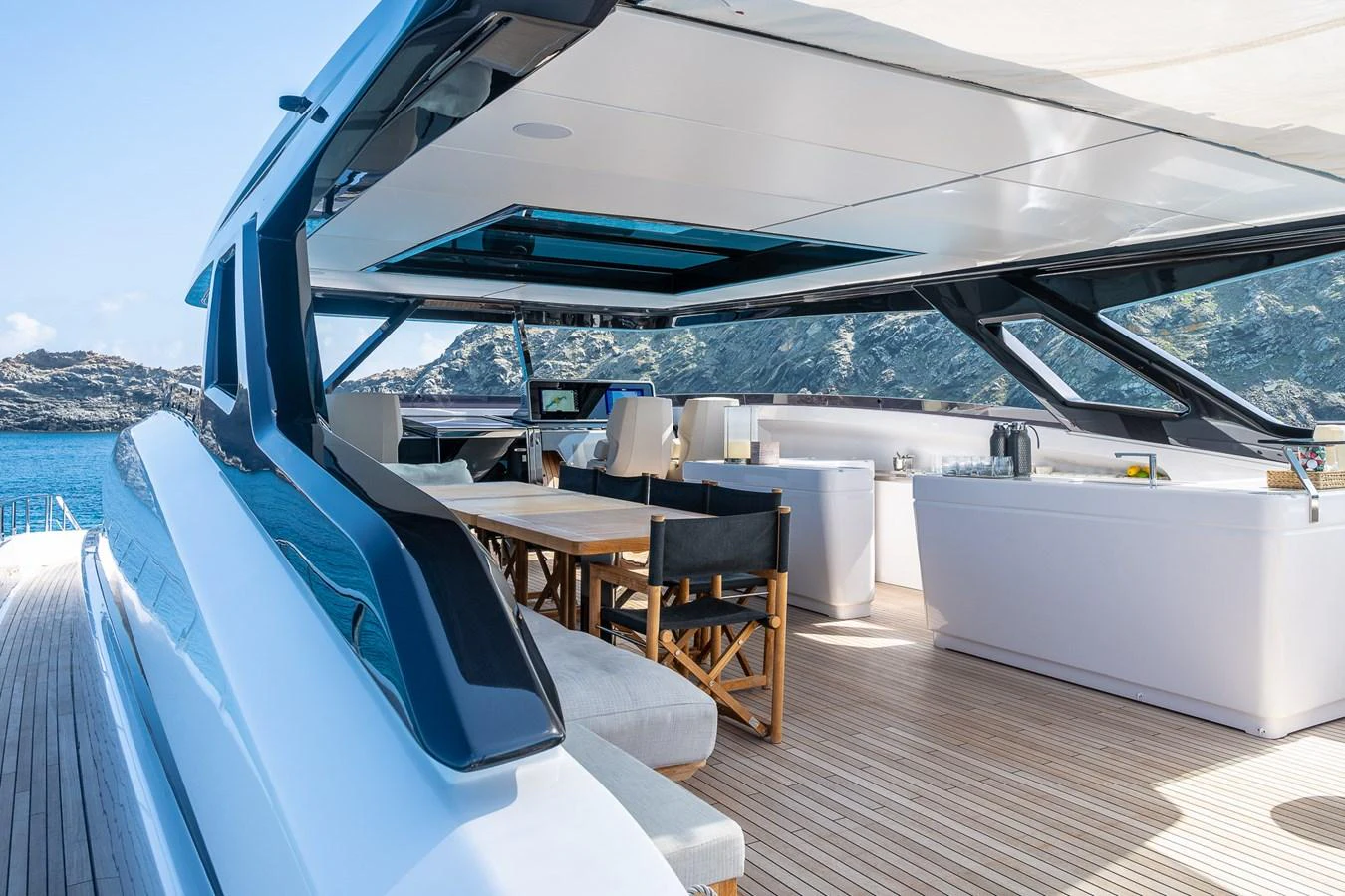 The flybridge offers a spacious and luxurious outdoor dining and lounging area with stunning views. aboard FREYA Yacht for Sale