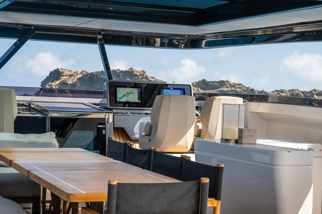 The helm area features modern navigation equipment and comfortable seating with a scenic view. aboard FREYA Yacht for Sale