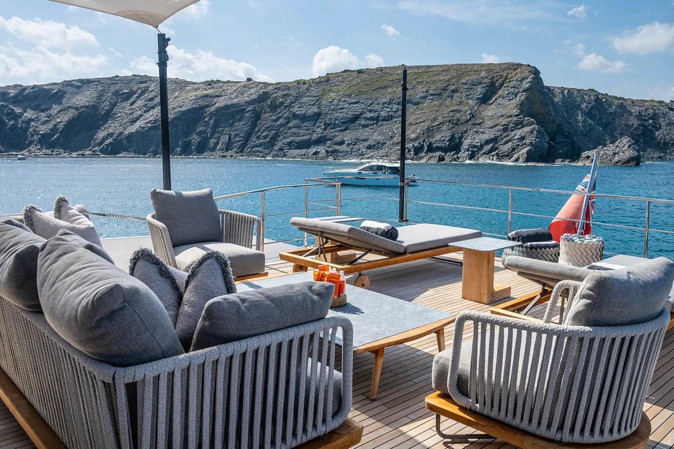 The aft deck offers a luxurious lounging area with comfortable seating and stunning ocean views. aboard FREYA Yacht for Sale