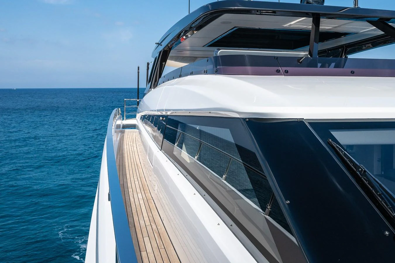 A sleek and modern yacht cruising on the open sea with a focus on its streamlined design and expansive windows. aboard FREYA Yacht for Sale