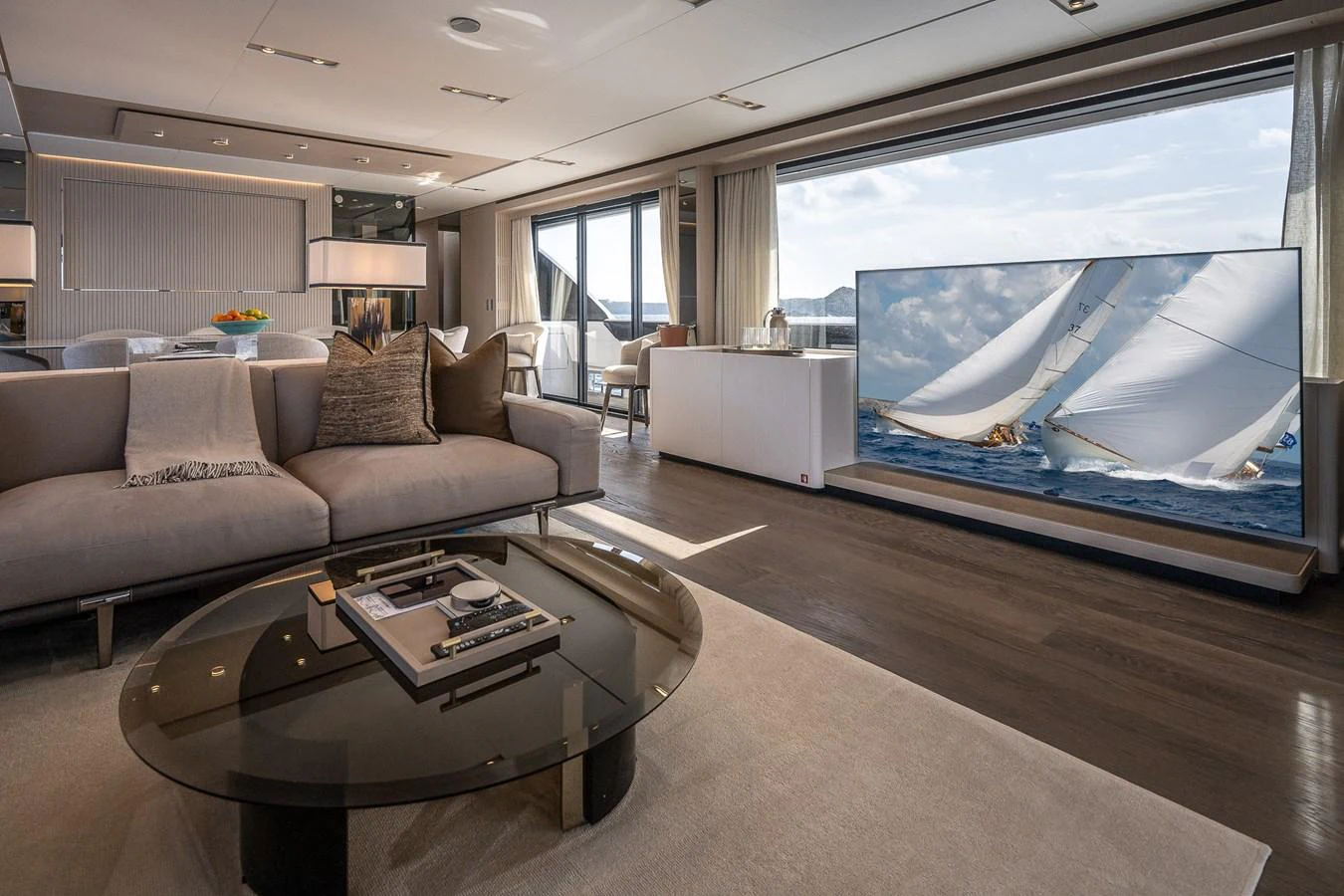 The salon features a spacious and elegant seating area with a large window offering stunning views. aboard FREYA Yacht for Sale