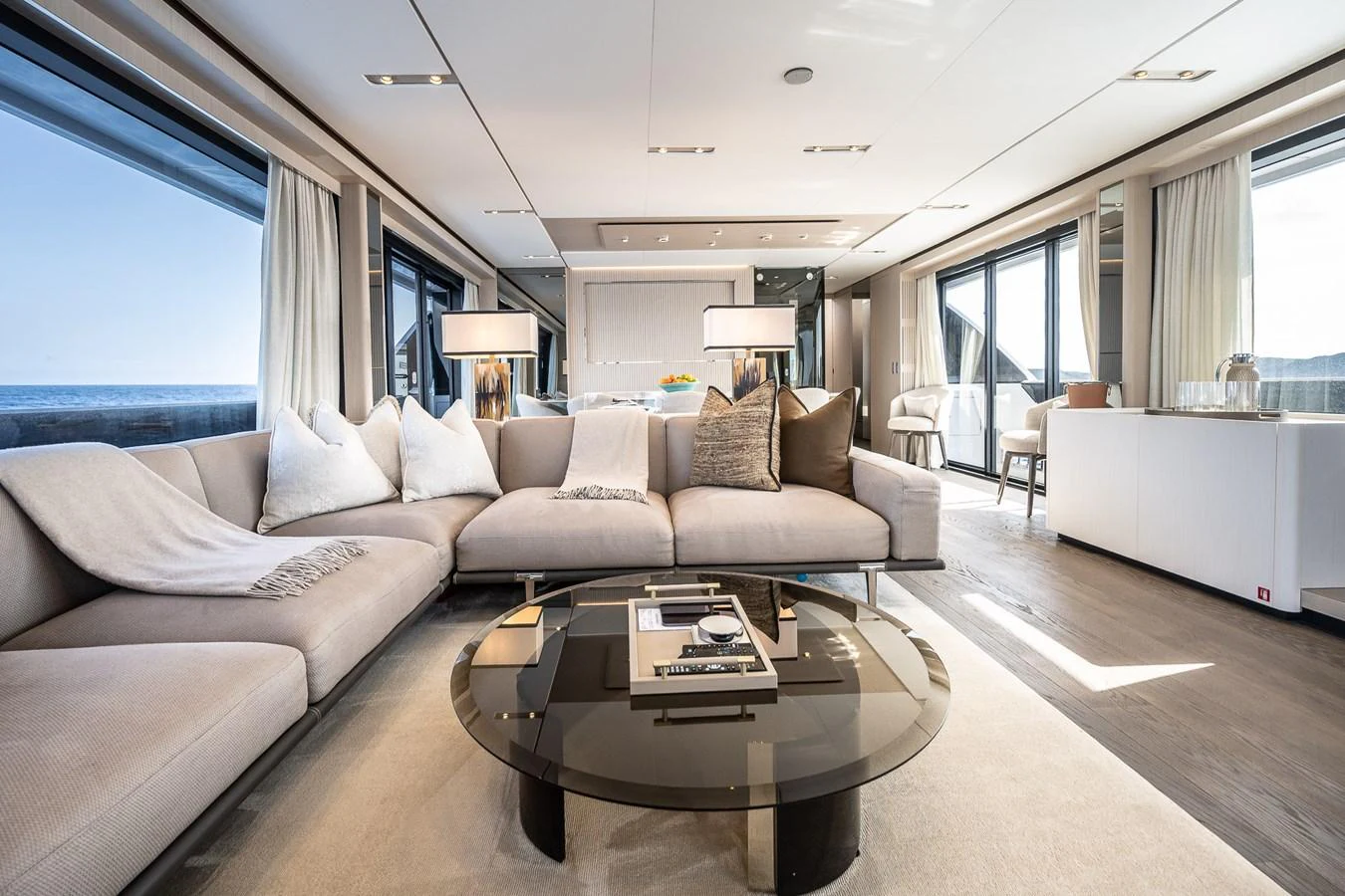 The spacious salon features elegant furnishings and panoramic windows offering stunning sea views. aboard FREYA Yacht for Sale