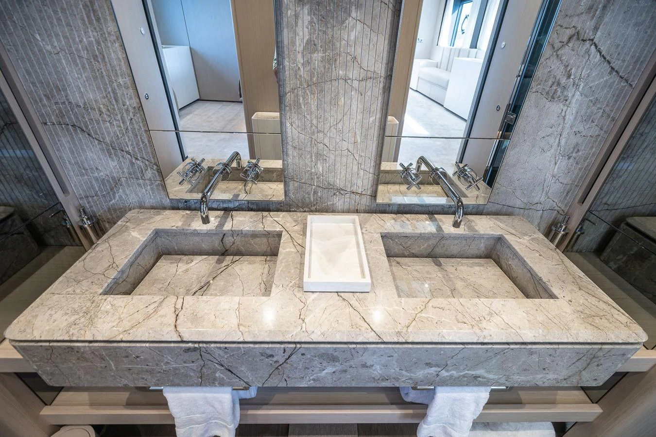 The luxurious bathroom features a double sink vanity with elegant marble countertops and modern fixtures. aboard FREYA Yacht for Sale
