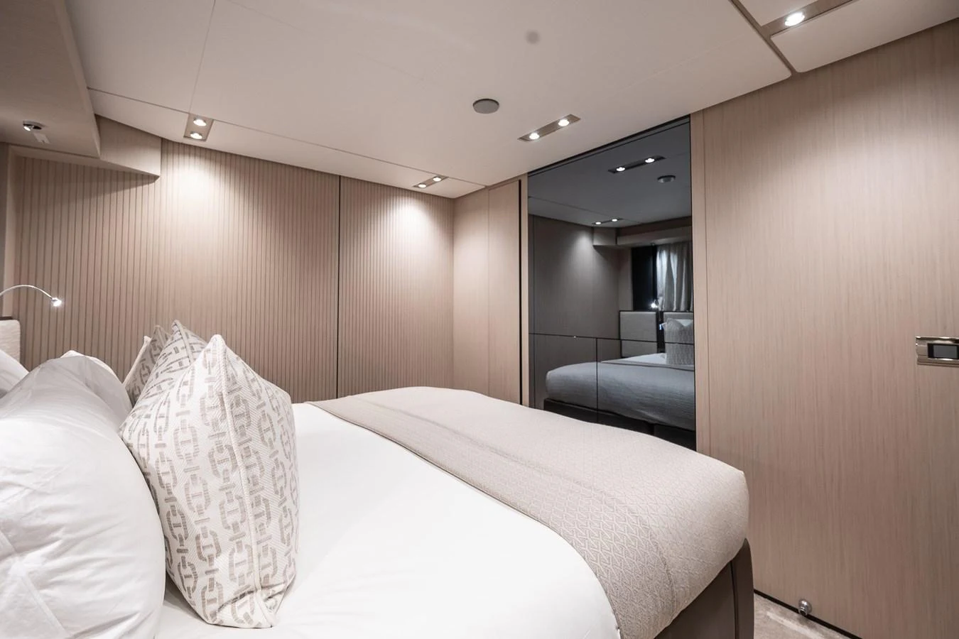The stateroom features a plush bed with elegant bedding and soft lighting, creating a serene and comfortable atmosphere. aboard FREYA Yacht for Sale