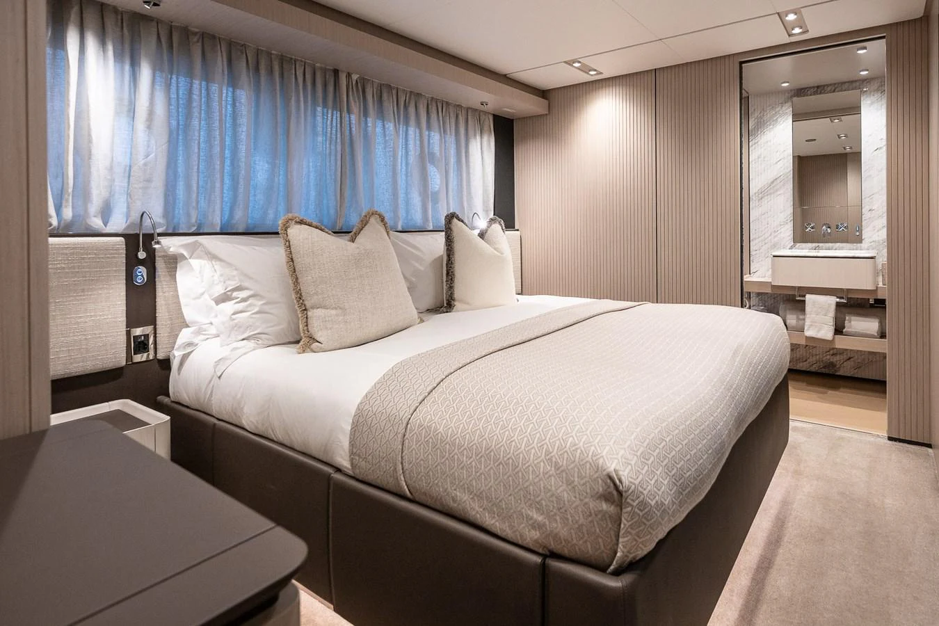 The stateroom features a plush bed with elegant linens and a modern ensuite bathroom. aboard FREYA Yacht for Sale