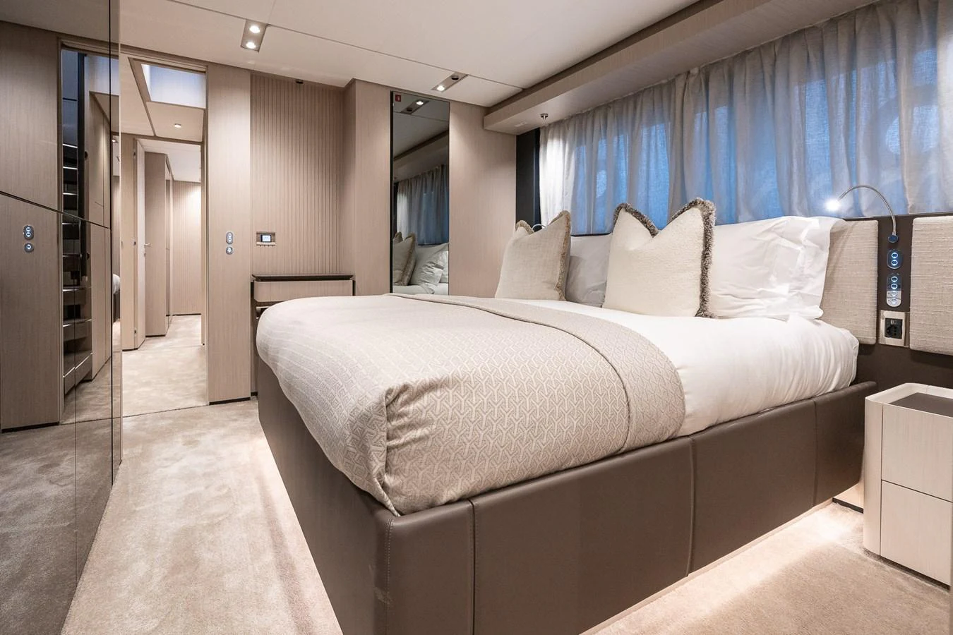 The stateroom features a luxurious bed with elegant bedding and soft lighting, creating a serene and inviting atmosphere. aboard FREYA Yacht for Sale