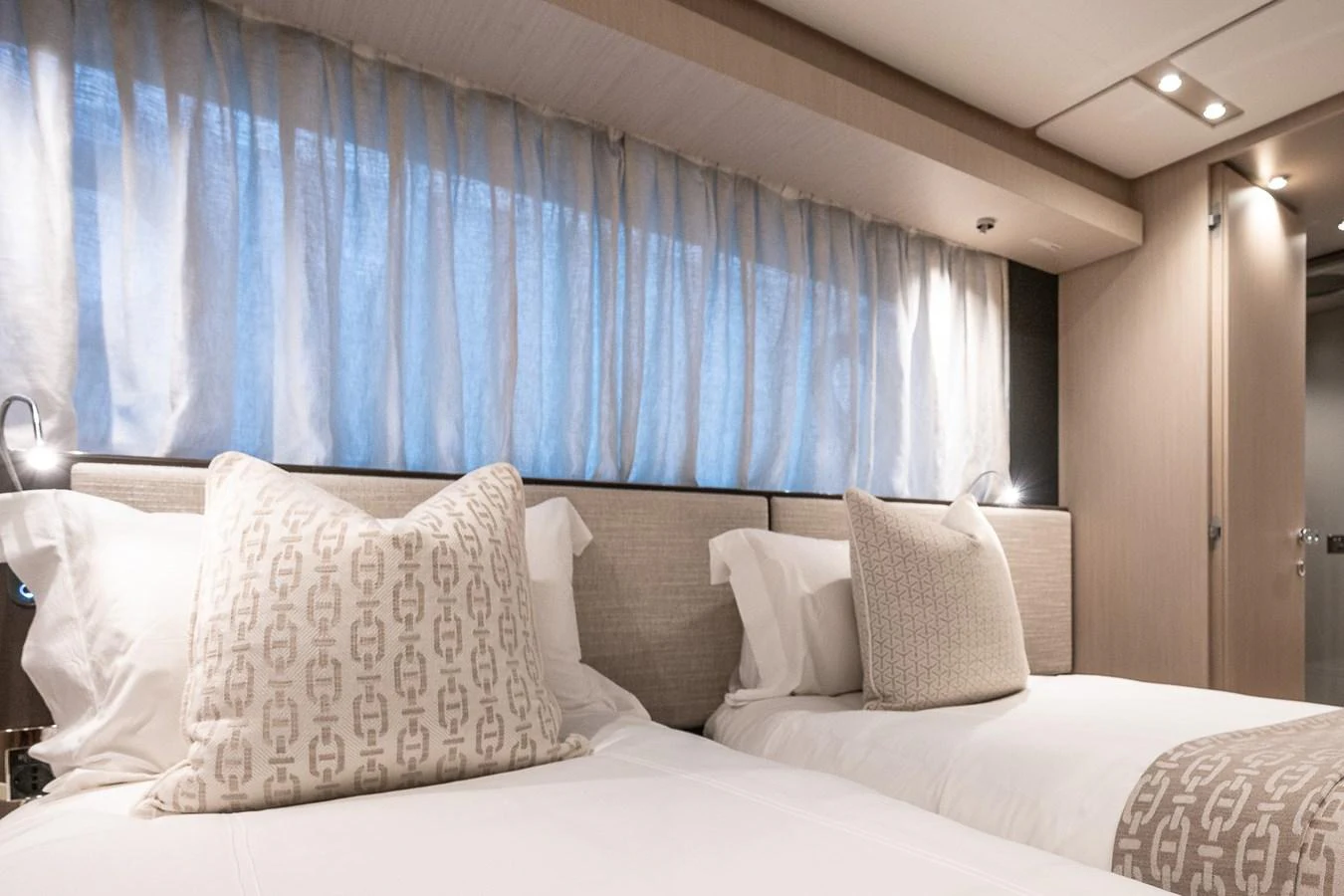 The guest stateroom offers a serene and comfortable sleeping area with twin beds and elegant decor. aboard FREYA Yacht for Sale