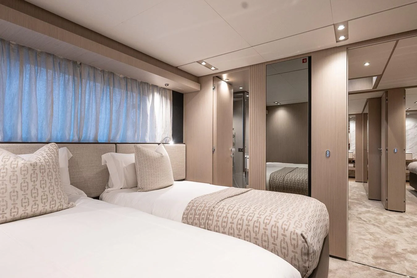 The guest stateroom features twin beds, elegant decor, and ample natural light. aboard FREYA Yacht for Sale