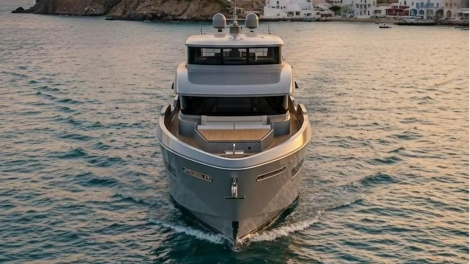 The yacht is captured head-on, showcasing its sleek design and modern lines as it cruises through calm waters. aboard ISY 90 EXPLORA Yacht for Sale