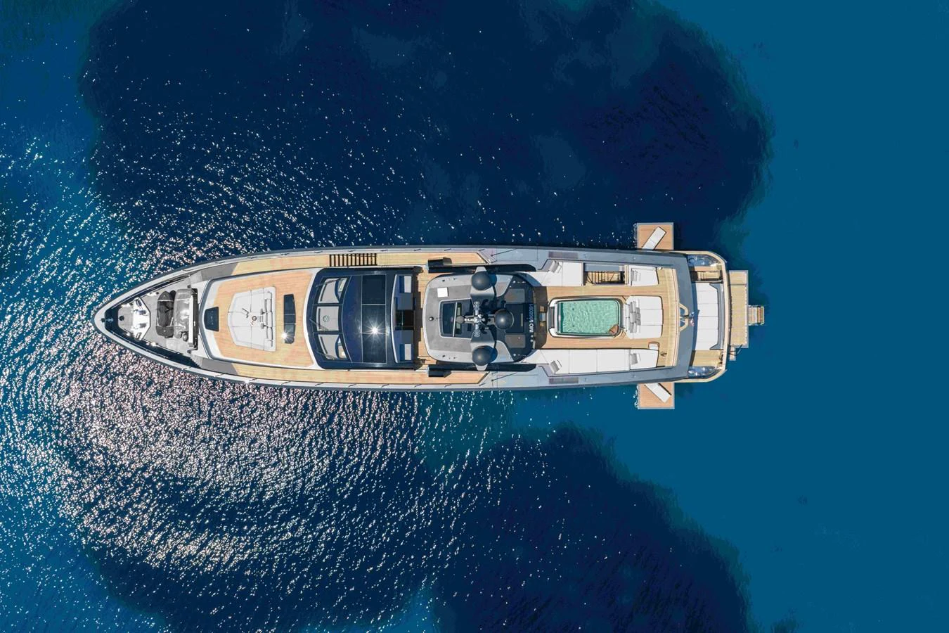 A stunning aerial view of a luxurious yacht floating on serene blue waters. aboard PANAM Yacht for Sale