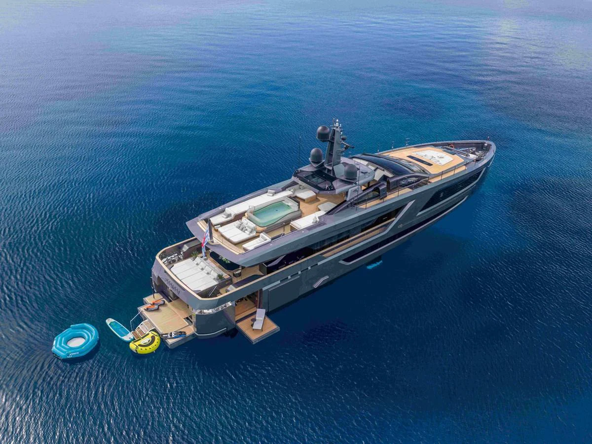 A luxurious yacht is anchored in calm, clear waters, showcasing its expansive deck and modern design. aboard PANAM Yacht for Sale