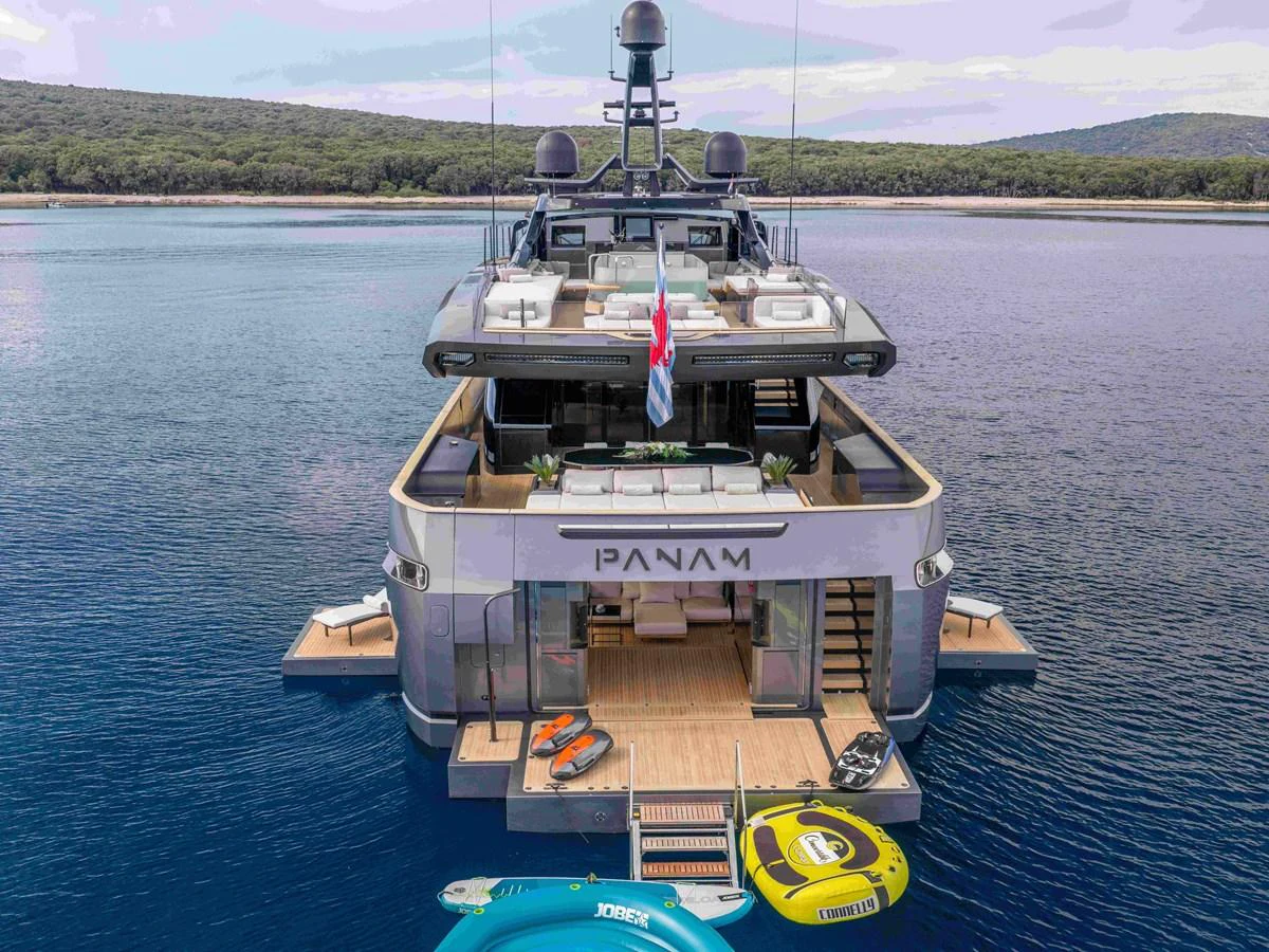 The yacht's aft deck features a spacious lounging area with easy access to water toys and the sea. aboard PANAM Yacht for Sale