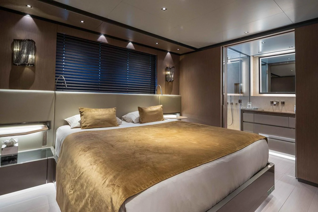The master stateroom features a luxurious bed with elegant lighting and modern decor. aboard PANAM Yacht for Sale