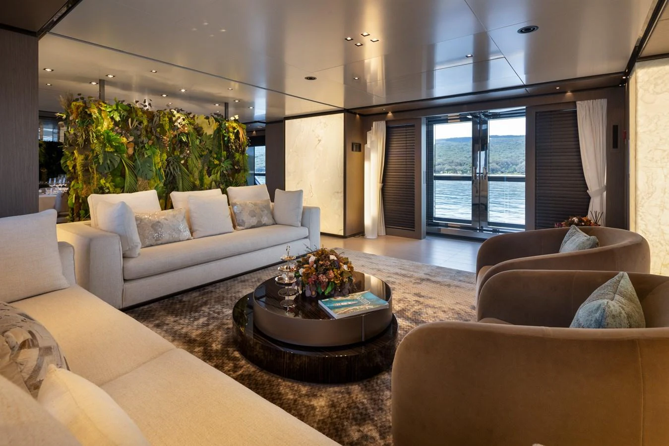 The salon offers a luxurious and spacious seating area with elegant decor and a beautiful view of the water. aboard PANAM Yacht for Sale