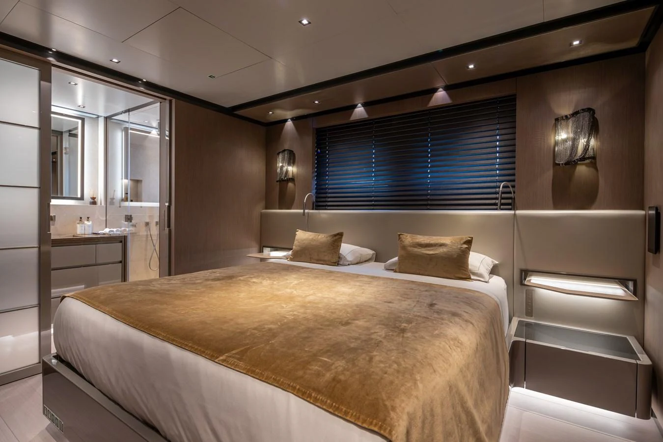 The master stateroom features a luxurious bed with plush bedding and modern lighting. aboard PANAM Yacht for Sale