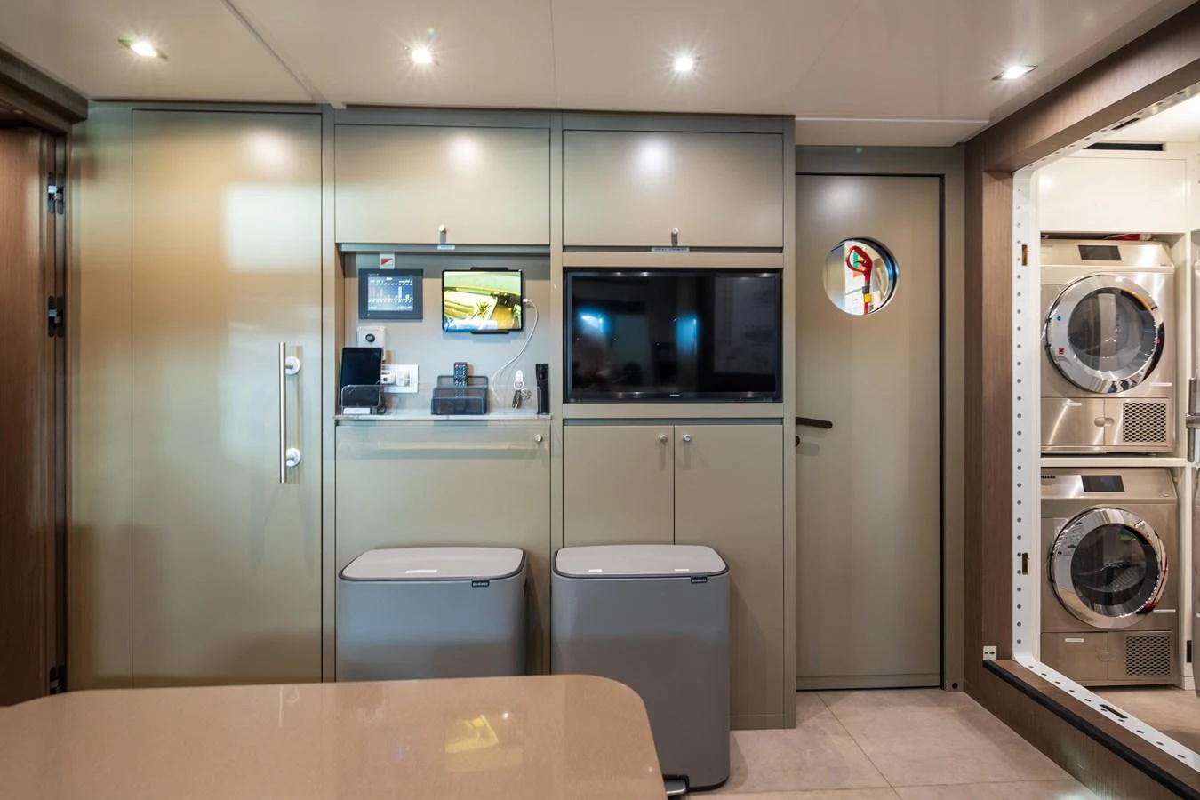 The yacht's interior features a modern utility area with built-in appliances and ample storage. aboard PANAM Yacht for Sale