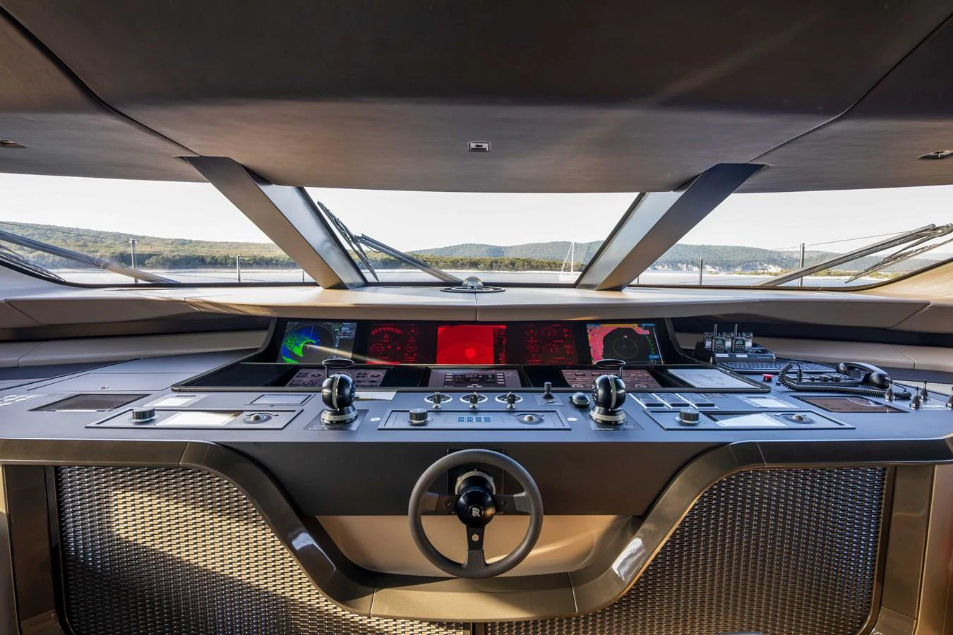 The helm station offers a commanding view with advanced navigation equipment and sleek design. aboard PANAM Yacht for Sale