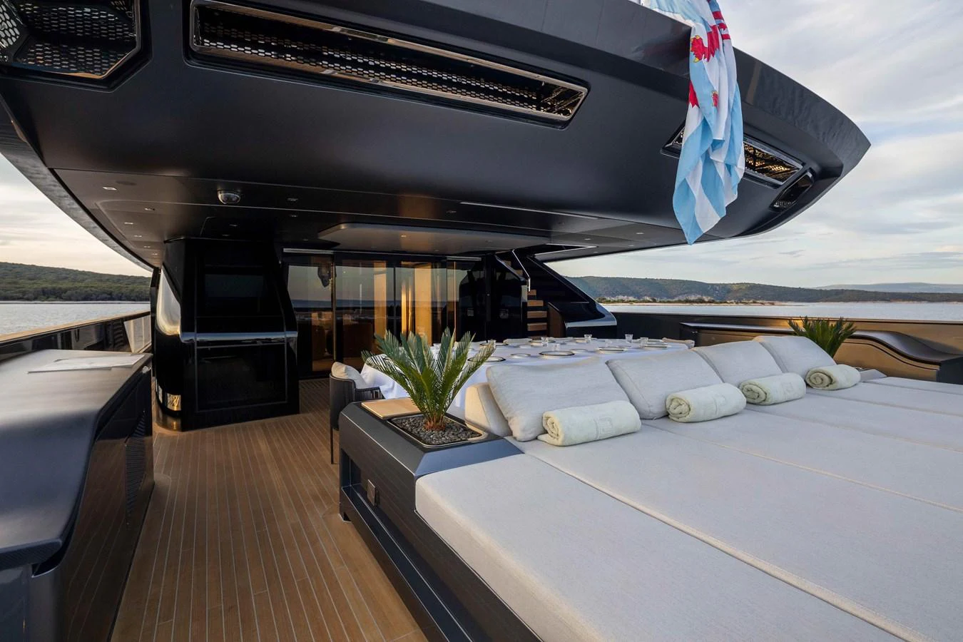 The sundeck features luxurious sunbeds and a shaded lounging area, perfect for relaxation. aboard PANAM Yacht for Sale