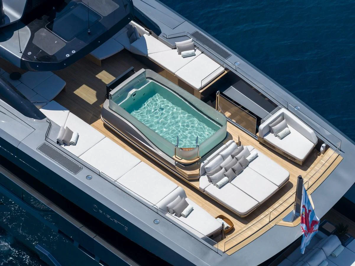 The sundeck features a luxurious hot tub surrounded by plush sun loungers, perfect for relaxation. aboard PANAM Yacht for Sale