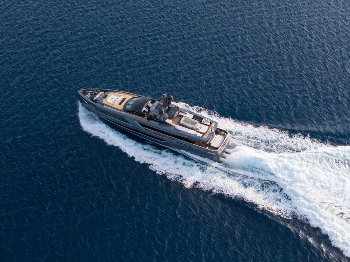 A sleek yacht cruises swiftly through the open sea, showcasing its elegant design and powerful performance. aboard PANAM Yacht for Sale