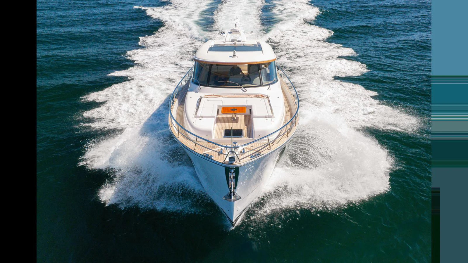 A sleek yacht cuts through the water, showcasing its powerful design and elegant lines. aboard LYRICA Yacht for Sale